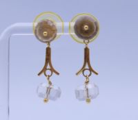A pair of unmarked gold and rock crystal earrings. Each 3 cm high. 6.6 grammes total weight.