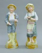 A pair of bisque porcelain figures. Each 32 cm high.