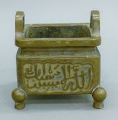 A Chinese bronze censer decorated with Arabic script. 12 cm wide.