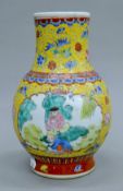 A Chinese yellow porcelain vase decorated with figures. 23.5 cm high.