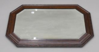 An early 20th century oak framed bevelled wall mirror. 79.5 x 50 cm.