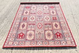 A red Persian wool rug. 239 x 171 cm.