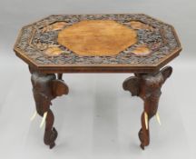 An Eastern carved hardwood elephant table. 83 cm long.