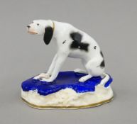 A Victorian Staffordshire porcelain dismal hound. 9.5 cm high.
