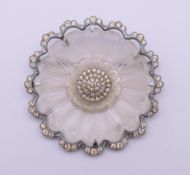 A white metal frosted glass flower brooch set with white paste stones. 6 cm diameter.