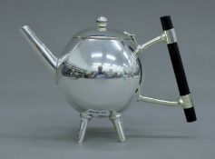 A Christopher Dresser-style silver-plated teapot. 14.5 cm high.