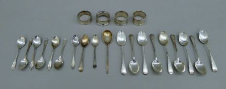 A quantity of silver teaspoons and four silver napkin rings. The longest spoon 14 cm long. 355.