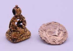 A silver gilt seal and an Art Nouveau silver button. The former 3.2 cm high.