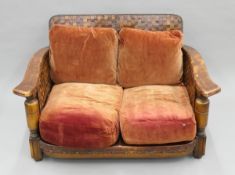 A early 20th century oak and leather two-seater settee. 120 cm wide.