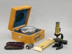 A vintage boxed student's microscope and various scientific instruments.