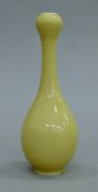 A Chinese yellow porcelain garlic-neck vase. 16 cm high.