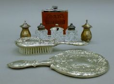 Two silver peppers, a silver-mounted cut glass cruet set,
