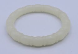 A white jade bangle. 6 cm inner diameter.
