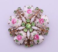 A brooch set with five enamelled petals, milk glass, white and green stones, possibly Norwegian. 5.