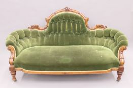 A Victorian walnut-framed button-back settee. 180 cm wide.