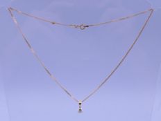 A 14 ct gold necklace with diamond drop pendant. The stone spreading to approximately 0.5 ct.