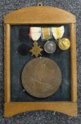 A framed set of World War I medals and a death plaque awarded to Herbert Arthur Palmer. 33.