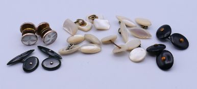 A quantity of mother-of-pearl and black, possibly jet, cufflinks. Oval black cufflinks 1.8 cm wide.