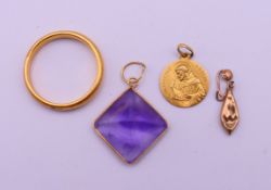 A 22 ct gold wedding band 6.4 grammes, an 18 ct gold St Francis pendant 1.