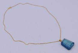 An aquamarine pendant on an 18ct chain, with certificate.