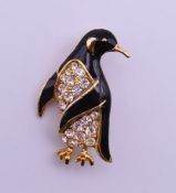 A boxed Pierre Cardin gold plated penguin form brooch with crystal stones and black enamel. 3.