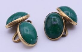 A pair of unmarked 18 ct gold and malachite cufflinks. Each 1.2 cm high. 6.6 grammes total weight.
