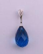 An 18 k white gold topaz and diamond pendant. 2.4 cm high.
