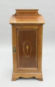 An Edwardian inlaid mahogany pot cupboard. 42 cm wide.
