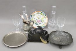 A pair of decanters, a quantity of glassware and metalware and a papier mache crumb tray and brush.