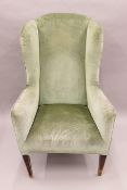 A late 19th/early 20th century upholstered wing back chair. 77 cm wide.