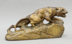 An Art Deco gilt-painted plaster model of a stalking lioness. 43 cm long.