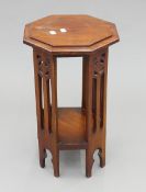 An Arts and Crafts mahogany octagonal side table. 24 cm wide.