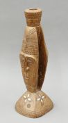 A Papua New Guinean mother-of-pearl inlaid carved wooden figural lamp base. 44 cm high.