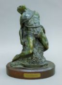 A bronze sculpture of Cu Chulainn mounted on a wooden plinth base. 27.5 cm high.