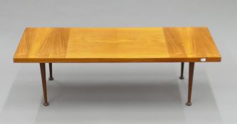 A mid-century coffee table. 117 cm long.