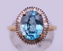 A 9 ct gold diamond and blue stone ring. Ring size O. 3.1 grammes total weight.