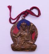 A Tibetan painted bronze pendant. 12 cm high including suspension loop.