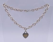 A Tiffany & Co silver heart pendant necklace. 38 cm long.