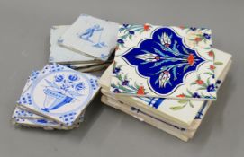 A quantity of blue and white Delft and other tiles. The largest 21 cm squared.
