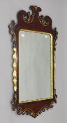 An 18th century-style gilt-heightened mahogany wall mirror. 106 x 60 cm.