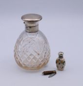 A silver-topped glass scent bottle,