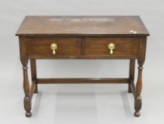 A early 20th century oak two-drawer side table. 102 cm wide.
