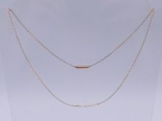 An unmarked platinum and gold chain. 48 cm long. 4 grammes.