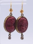 A pair of 19th century yellow metal-mounted lava stone cameo earrings. 3.