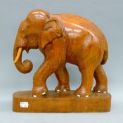 A carved wooden elephant. 33 cm high.