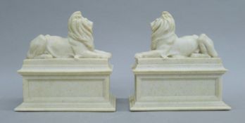 A pair of composite recumbent lions. Each 20 cm high.