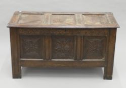 An 18th century three-panel carved oak coffer. 120 cm wide.