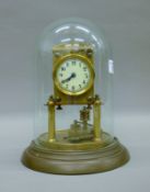 A brass anniversary clock housed under a glass dome. 25 cm high.
