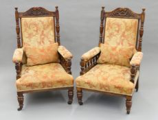 A pair of Victorian upholstered oak open armchairs. Each 67 cm wide.