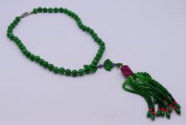 A jade and pink tourmaline necklace with a diamond set clasp. 52 cm long.
